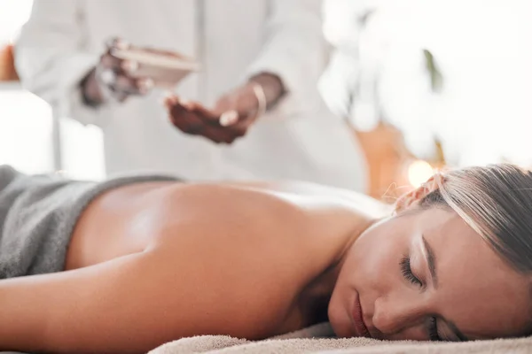 Woman, spa and luxury back massage on table for health, zen and wellness of body. Client with a masseuse for healing, relax and therapy with self care and cosmetic service for detox and holistic time.
