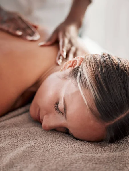 Face, back massage with masseuse, woman at holistic center or spa with wellness, physical therapy with hands and zen. Health, peace of mind and stress relief, self care and lifestyle with healing.