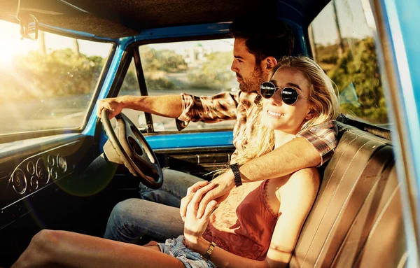 This is the ultimate road trip. a young couple out on a road trip with their truck