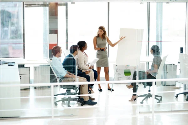 Shes got ideas that she needs to share. Full length shot of a businesswoman giving a presentation during a meeting in the boardroom