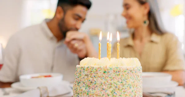 Cake, anniversary or birthday, couple celebrate and romantic together, kiss and love during dinner date. Young, man and woman, relationship growth and spending quality time, food and dessert to enjoy.