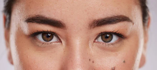 Asian, eyes and face with vision and beauty, microblading with lashes, contact lens and eye care zoom. Makeup, eyeliner with eyebrow, portrait and skin with optometry, cosmetics and female in studio.