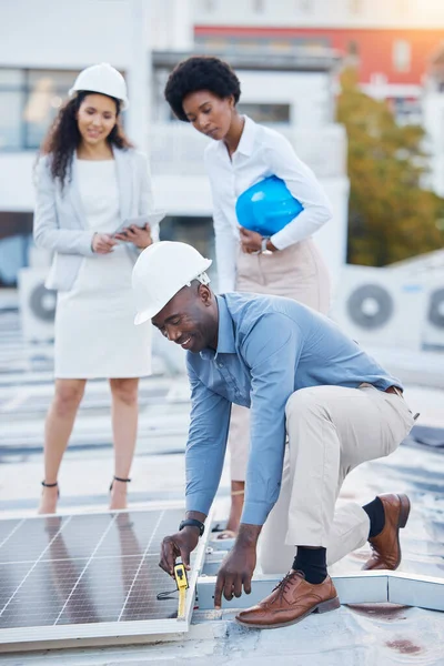 Black man, engineer team and solar panel with construction worker technician outdoor. Businessman, renewable energy staff and industrial eco friendly panels of maintenance employee and handyman.