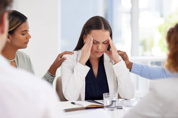 Business woman, stress or headache in meeting with team for support on mental health and anxiety. Corporate leader with depression, burnout fatigue or problem while tired and frustrated in office.