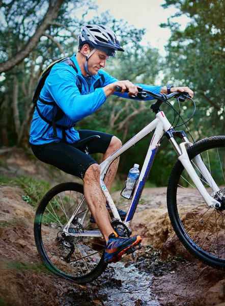 stock image Rough terrain is nothing for him. a male cyclist riding along a mountain bike trail