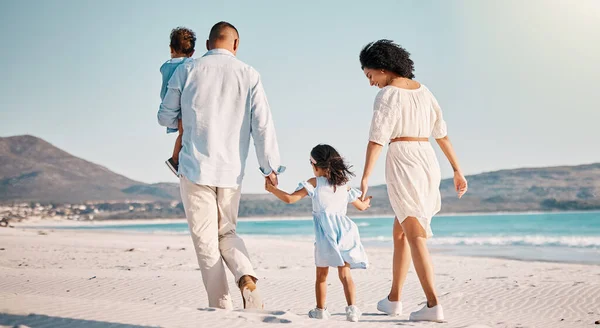 Holding hands, family love and beach walking, bonding or enjoy quality time together for vacation, holiday peace or freedom. Sea water, ocean and back view of travel people in Rio de Janeiro.