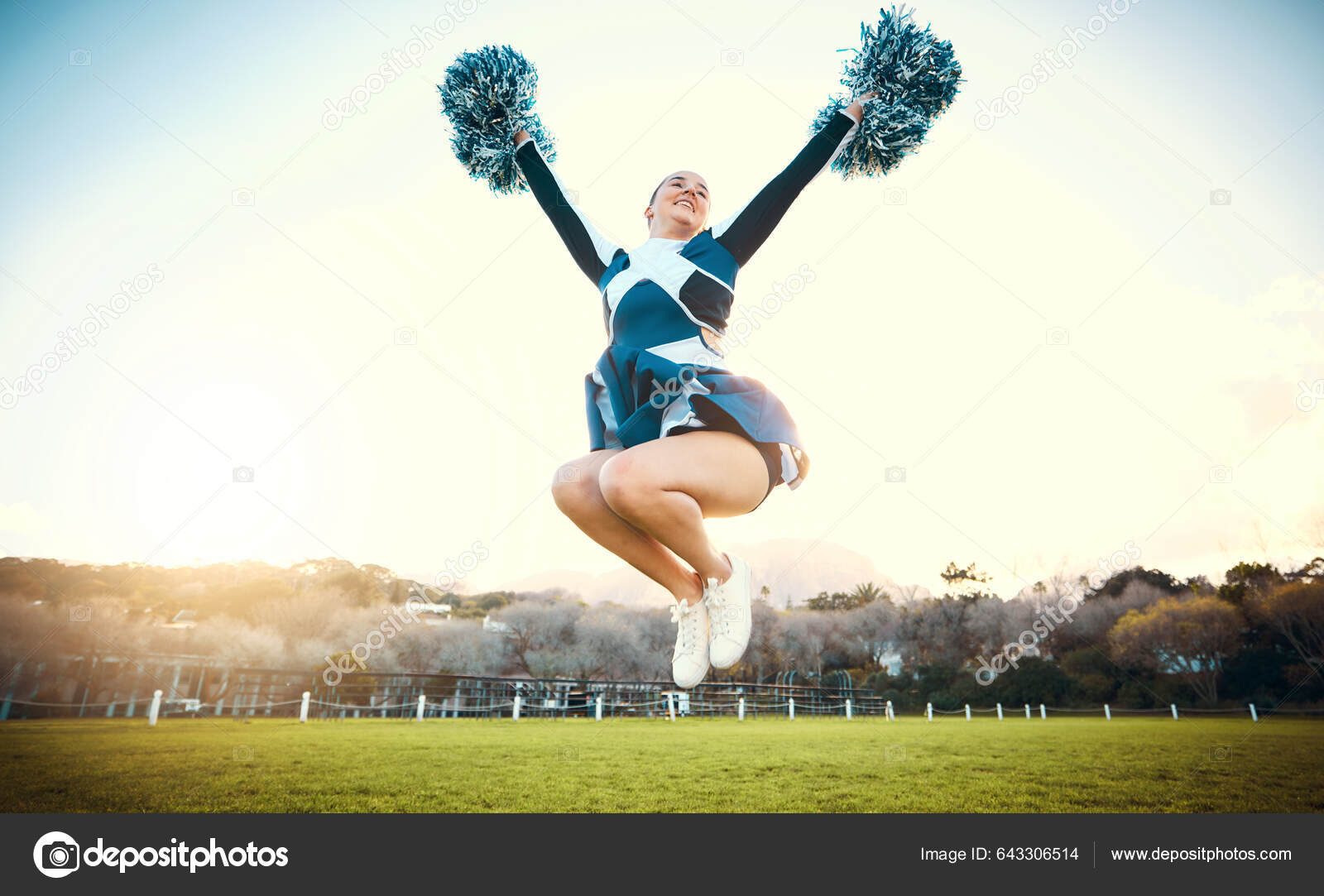 Cheerleader Girl Dancing with Pompons on Sport Event Competition