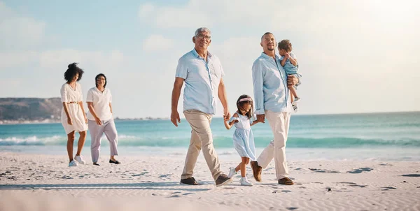 Grandparents, parents and children walking on beach for holiday, vacation and weekend trip by sea. Travel, summer and kids holding hands with big family for adventure, journey and relaxing together.