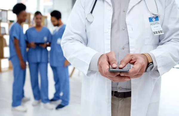 Healthcare, hospital and hands of doctor with phone for research, telehealth and medical consulting. Nurse team, clinic and health worker on smartphone for patient data, wellness app and internet.
