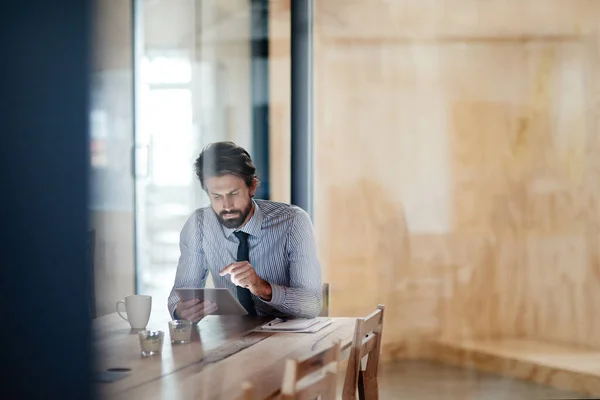 stock image He doesnt know the meaning of 9-5. a businessman using a digital tablet