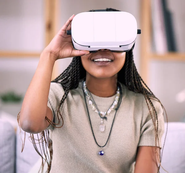 stock image Future, virtual reality glasses and black woman in lounge, esports and connection for metaverse. Futuristic, African American girl with vr, smile and 3d gaming in living room or stress relief.