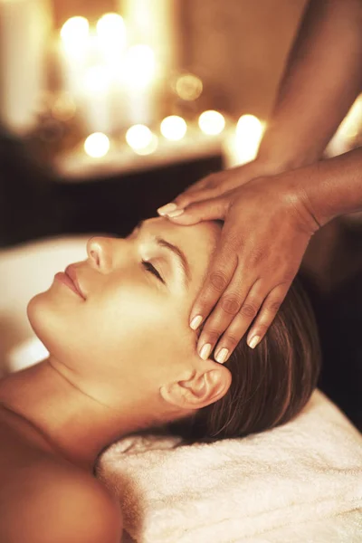 Massage therapy is the oldest form of medicine. Closeup shot of a young woman enjoying a head massage at the spa
