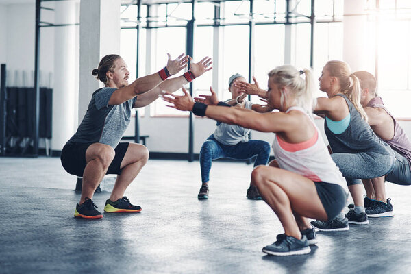 Shot of a fitness instructor working with a group of people at the gym.