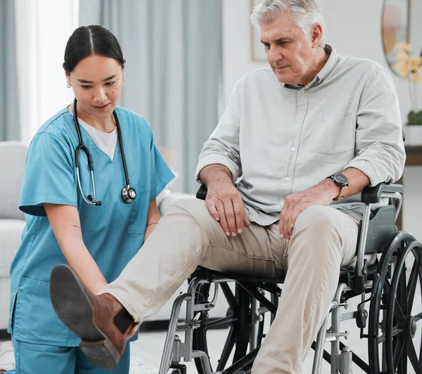 Wheelchair help, nursing home and man with injury or disability with nurse support. Wellness, healthcare and retirement of a elderly person with foot pain from a medical problem with caregiver.