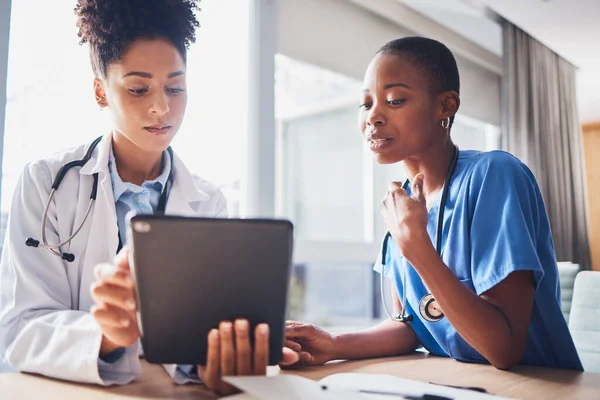 Tablet, black people or nurses with medical research reading news or tests results in hospital together. Teamwork, digital tech or African doctors planning or speaking of healthcare report on website.