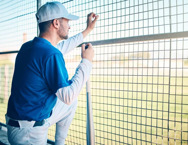 Sports, ready and man watching baseball, training and thinking of a strategy for a game. Fitness, idea and player waiting to start a match, competition or sport on a field for fitness and exercise.