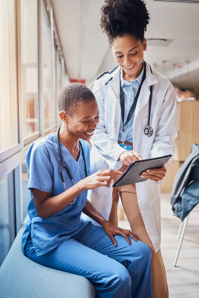 Tablet, black women or doctors planning surgery in conversation about medical news or tests results in hospital. Teamwork, happy people or African nurses speaking of healthcare report or web research.