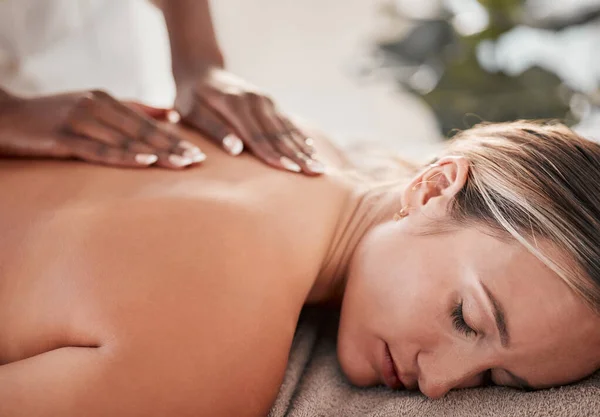 Hands, back massage with masseuse, woman at holistic center or spa with wellness, physical therapy and zen. Health, body rub at luxury resort and face with stress relief, self care and lifestyle.