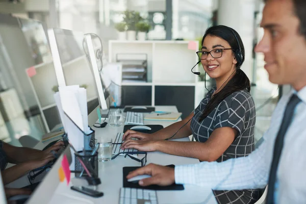 Portrait of a happy and confident young woman working in a call center.