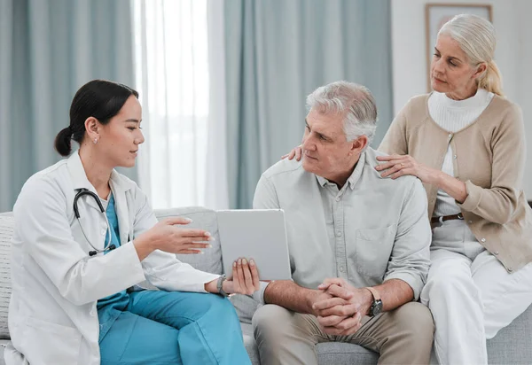 stock image Nurse with tablet results consulting old couple in hospital after surgery or medical test report for support. News, healthcare clinic or doctor working or helping a depressed or sick elderly person.