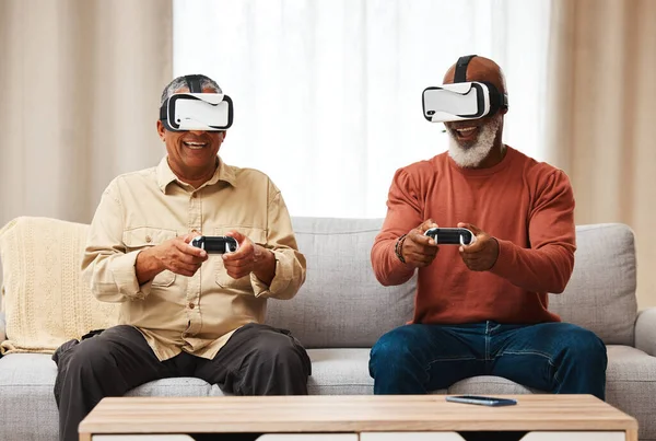 Friends, vr and senior men gaming in home on sofa in living room while laughing. 3d virtual reality, metaverse gamer and smile of happy retired people playing fun futuristic games with controller