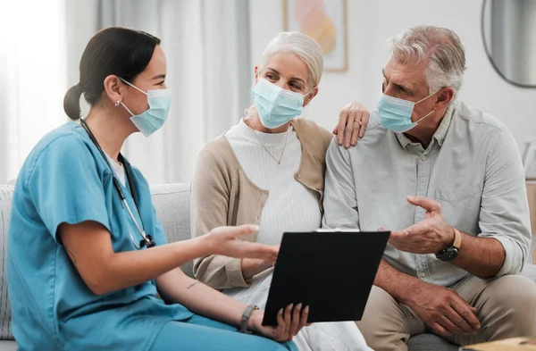 Checklist, old couple or nurse in consultation for covid in hospital about medical test news or results. Face masks, coronavirus or doctor consulting in healthcare clinic nursing sick elderly people.