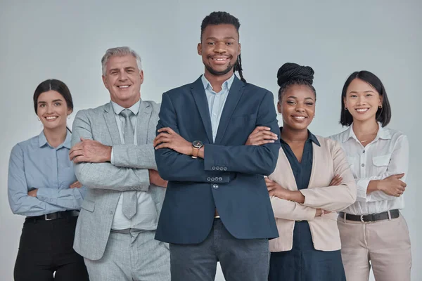Leadership, team and business people with crossed arms in a studio with confidence, unity and teamwork. Collaboration, corporate and portrait of a group of employees standing by a gray background