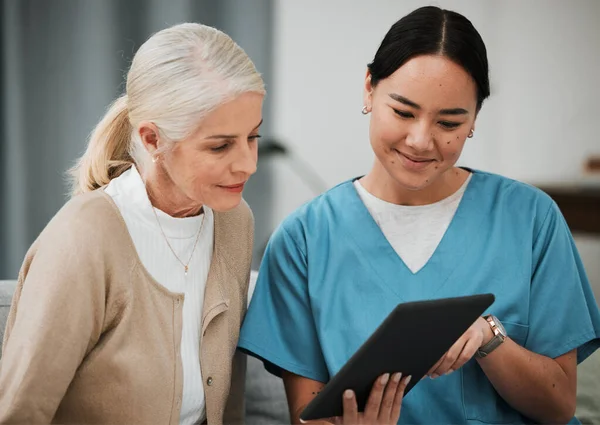 Tablet, news or nurse with old woman consulting after surgery or medical test results for support. Meeting, healthcare clinic or doctor reading or helping a sick elderly patient with an online report.