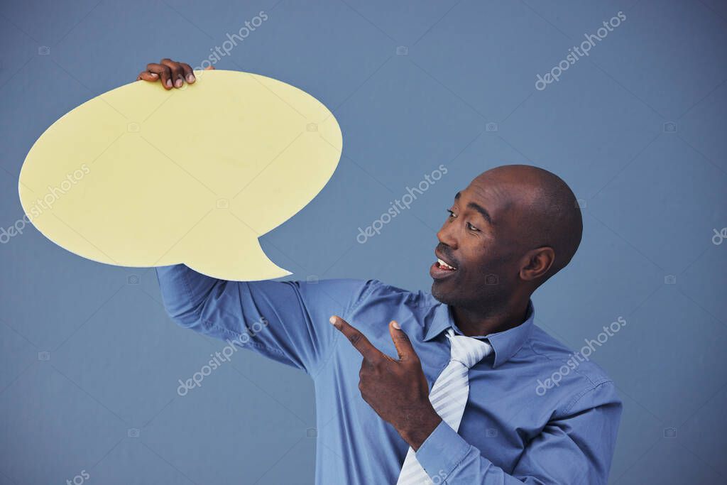 Black man, social media and mockup with speech bubble for advertising or marketing against a blue studio background. African American male pointing to shape for voice, opinion or text advertisement.