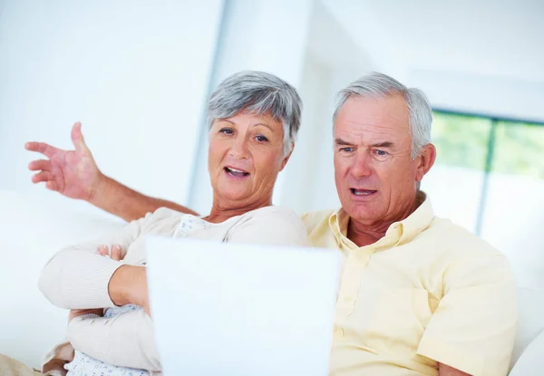 stock image Shocking bills. Shocked mature couple reading domestic bill while sitting on couch