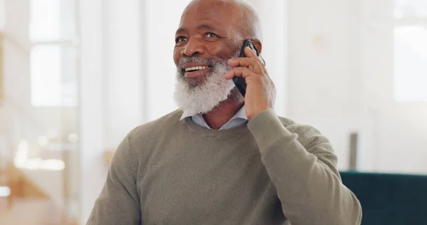 Senior black man, work and home with phone call, communication and laptop on desk for online crm job. Mature worker, home office and using phone for conversation, discussion or negotiation with clien.