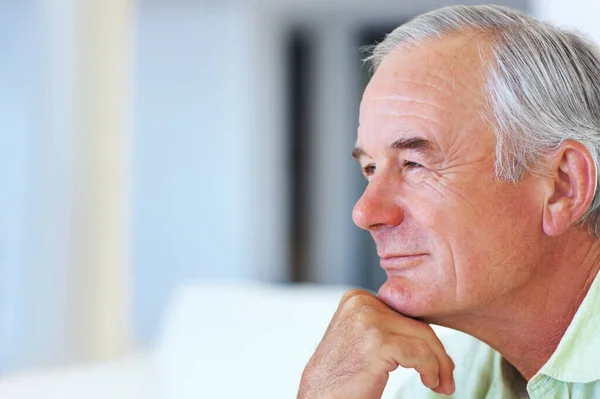 stock image Thoughtful mature man. Closeup of thoughtful mature man at home looking away in deep thought