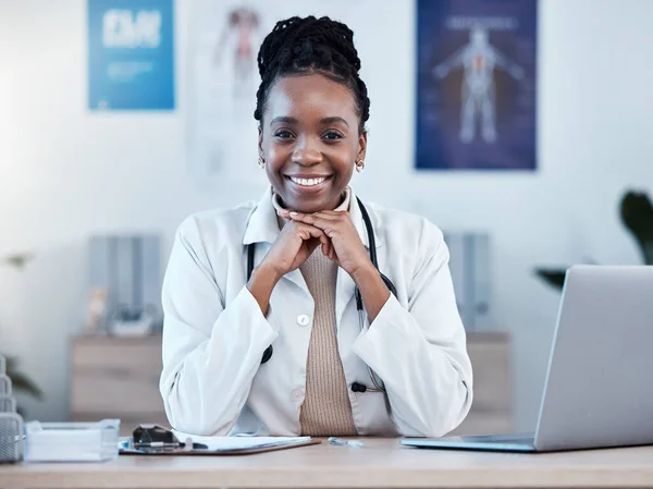 Black woman, doctor in portrait and health, smile in office and laptop, medical professional and happy in career. Female physician, hands and healthcare mindset with cardiologist at clinic and leader.