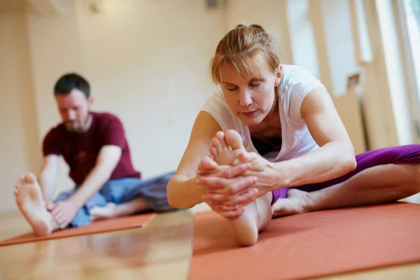 Staying flexible with yoga. two people doing yoga together in a studio