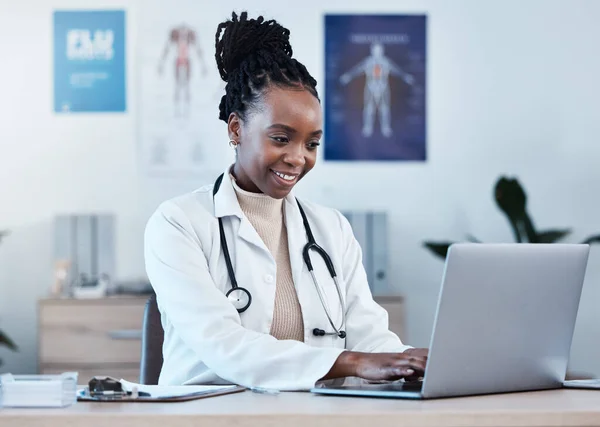 Laptop, medical research and doctor typing medicine report, healthcare study or review digital archive database. Reading online info, hospital clinic and black woman doing analysis of health results.
