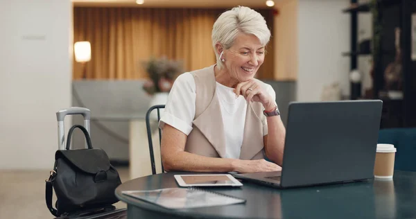 Video call, virtual meeting and laptop with a business woman remote working from an airport waiting terminal. Computer, communication and business meeting with a senior female employee at work.