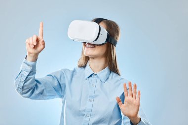 VR kulaklık, kadın ve metaevren, mavi arka planda sanal ekranı olan fütüristik teknoloji. Mutlu genç bayanla dijital, video oyunu ve kullanıcı deneyimi, eller ve görünmez düğmeye basın.