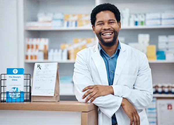 Pharmacy portrait, medicine pills and happy man in drugs store, pharmaceutical shop or healthcare dispensary. Hospital retail clerk, medical commerce business and African pharmacist for help support.