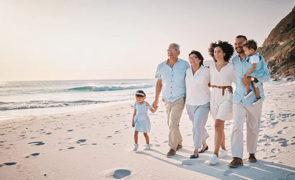 Family, grandparents and children walking on beach for holiday, vacation and bonding on weekend trip. Travel mockup, summer and kids holding hands with mom and dad for adventure, sunset and relax.
