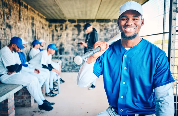 Baseball player, black man portrait and sports stadium dugout with softball team at ball game. Training, exercise and motivation of a young athlete from Dallas with a smile for fitness workout.