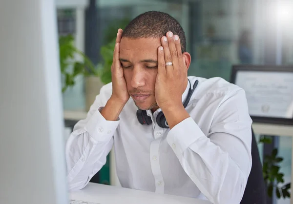 Stress, anxiety or black man in call center with burnout or migraine pain at customer services help desk. Tired, headache or sick sales consultant frustrated with mistakes in a telemarketing company.