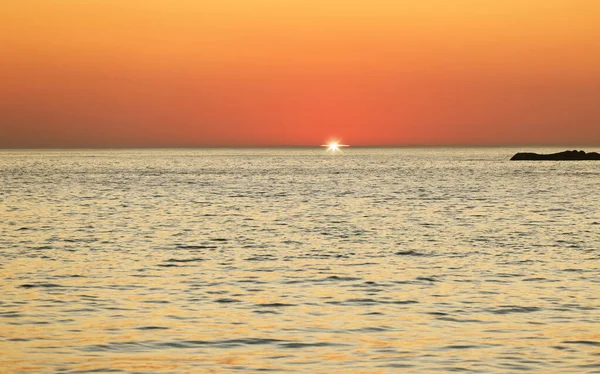 stock image Sunset, ocean and horizon with a view over the sea during summer under an orange sky for mockup. Nature, water and earth with waves on a seascape for zen, peace or inspiration on a sunrise backdrop.