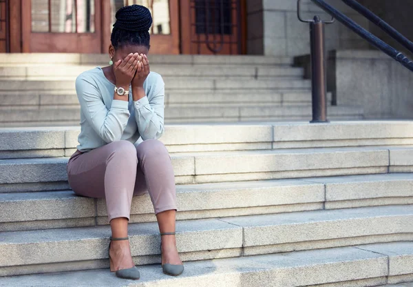 Stress, crying and black woman on steps with anxiety, panic attack or mental health problem. Corporate, pressure and lady with headache outside of office building, worry or mistake, fail or crisis.