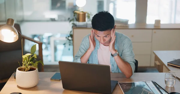 Laptop, business asian man and stress, tired or headache working in office with fatigue, anxiety or depression. Sad, depressed and mental health risk of digital online worker or employee burnout and .