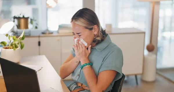stock image Woman, covid and sinus in office with sneeze, tissue and runny nose while working on laptop. Business woman, allergies and unwell corporate employee sneezing and suffering flu, cold and allergy.