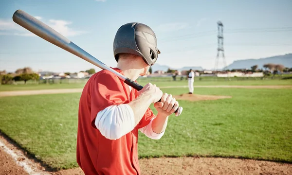 Baseball, bat and field with a sports man outdoor, playing a competitive game during summer. Fitness, health and exercise with a male athlete or player training on a pitch for sport or recreation.