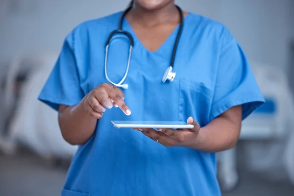 Black woman, hands and nurse in hospital with tablet for healthcare planning, wellness analysis or online test. Nursing closeup, digital technology and medical services for medicine, doctor or clinic.