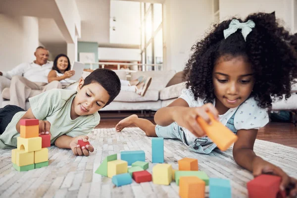 Kids, building blocks and creative learning in family home, living room floor and ground for growth, development and fun. Focus children, educational brick toys and youth creativity in lounge house.