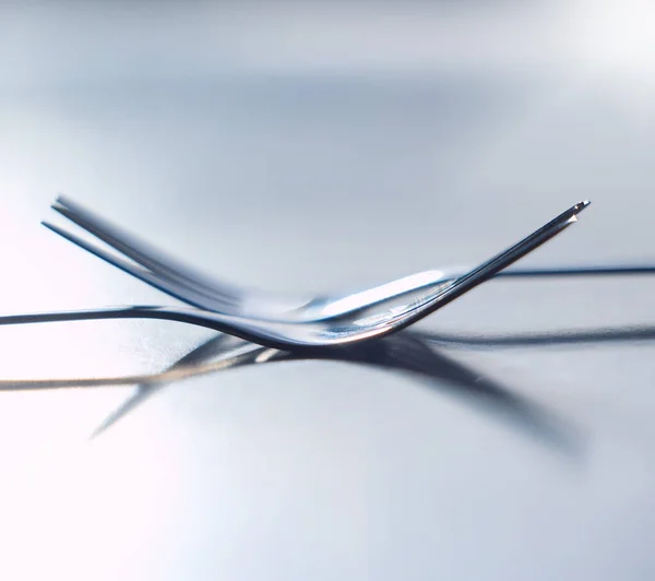Forks, balance and utensils on a table in the kitchen for eating at a restaurant, home or house. Stainless steel, metal or silver parallel cutlery, tableware or object to eat or cook a meal