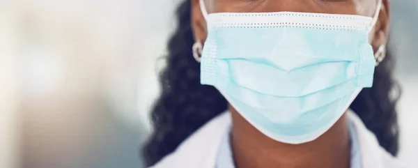 Black woman in healthcare, covid and a doctor with a face mask closeup. Safety, security and risk for employee working in the medical field. Medicine, caution and insurance of a safe work environment.